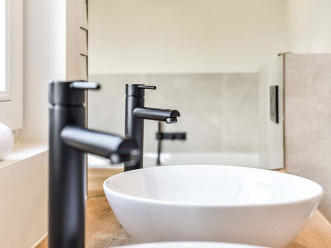 Dual bathroo basin sinks with black faucets